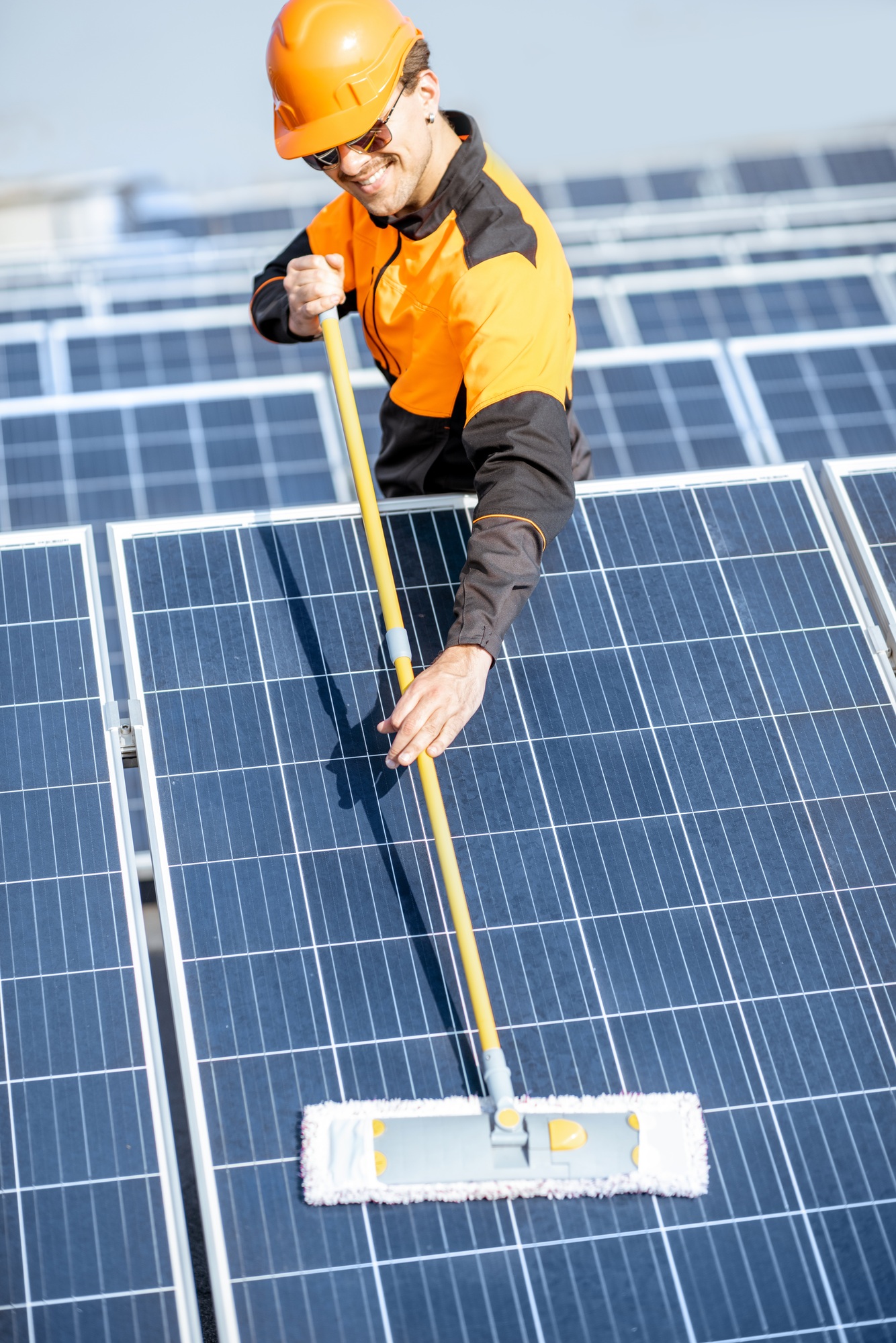 Workman cleaning solar panels